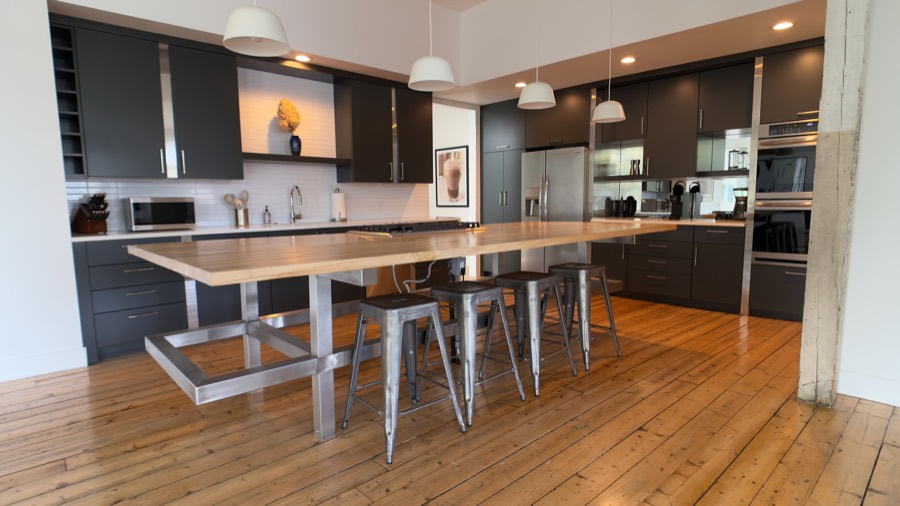 Chef's kitchen with butcher-block island and Tolix stools