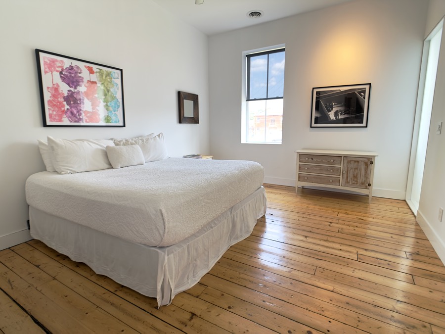 King bedroom with original plank floors